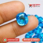 Faceted Blue Zircon gemstone held between fingertips