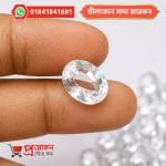Faceted Sri Lankan White Zircon gemstone held between fingertips