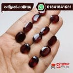 Multiple faceted oval and rectangle cut natural reddish-brown African Gomed gemstones displayed on an open hand by Proyojonstore