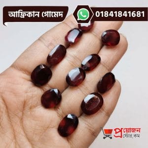 Multiple faceted oval and rectangle cut natural reddish-brown African Gomed gemstones displayed on an open hand by Proyojonstore
