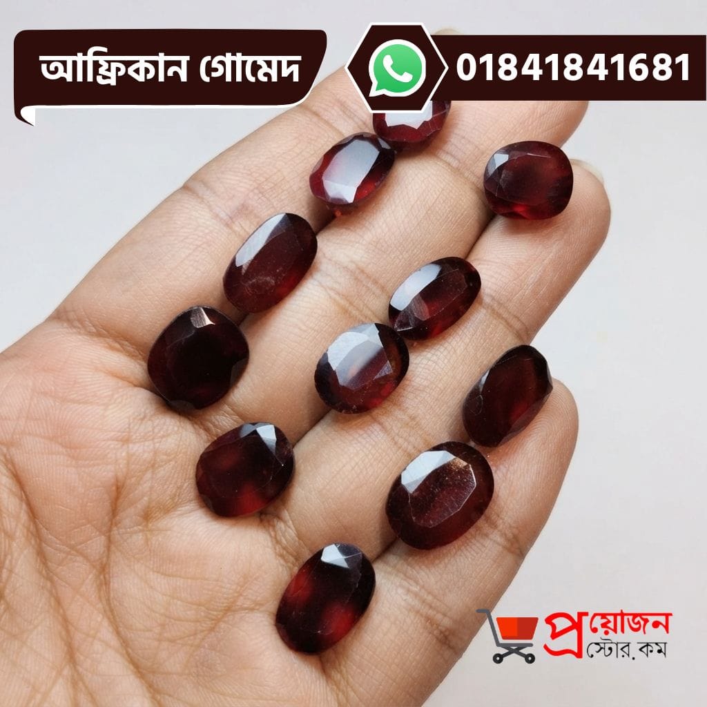 Multiple faceted oval and rectangle cut natural reddish-brown African Gomed gemstones displayed on an open hand by Proyojonstore