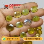 Multiple faceted oval natural light-yellow and bi-color Ceylon Sapphire gemstones displayed on an open hand by Proyojonstore