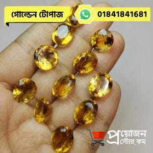 Multiple faceted oval and round natural golden-yellow Topaz gemstones arranged across an open hand by Proyojonstore