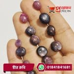 Multiple round and oval polished natural Star Ruby gemstones displayed across an open hand by Proyojonstore