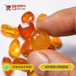Close-up of a sparkling oval faceted golden-yellow Bangkok Yellow Sapphire gemstone held between fingertips by Proyojonstore