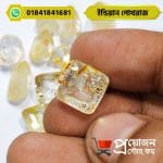 Close-up of a square cut natural Indian Yellow Sapphire Pokhraj gemstone held between fingertips by Proyojonstore