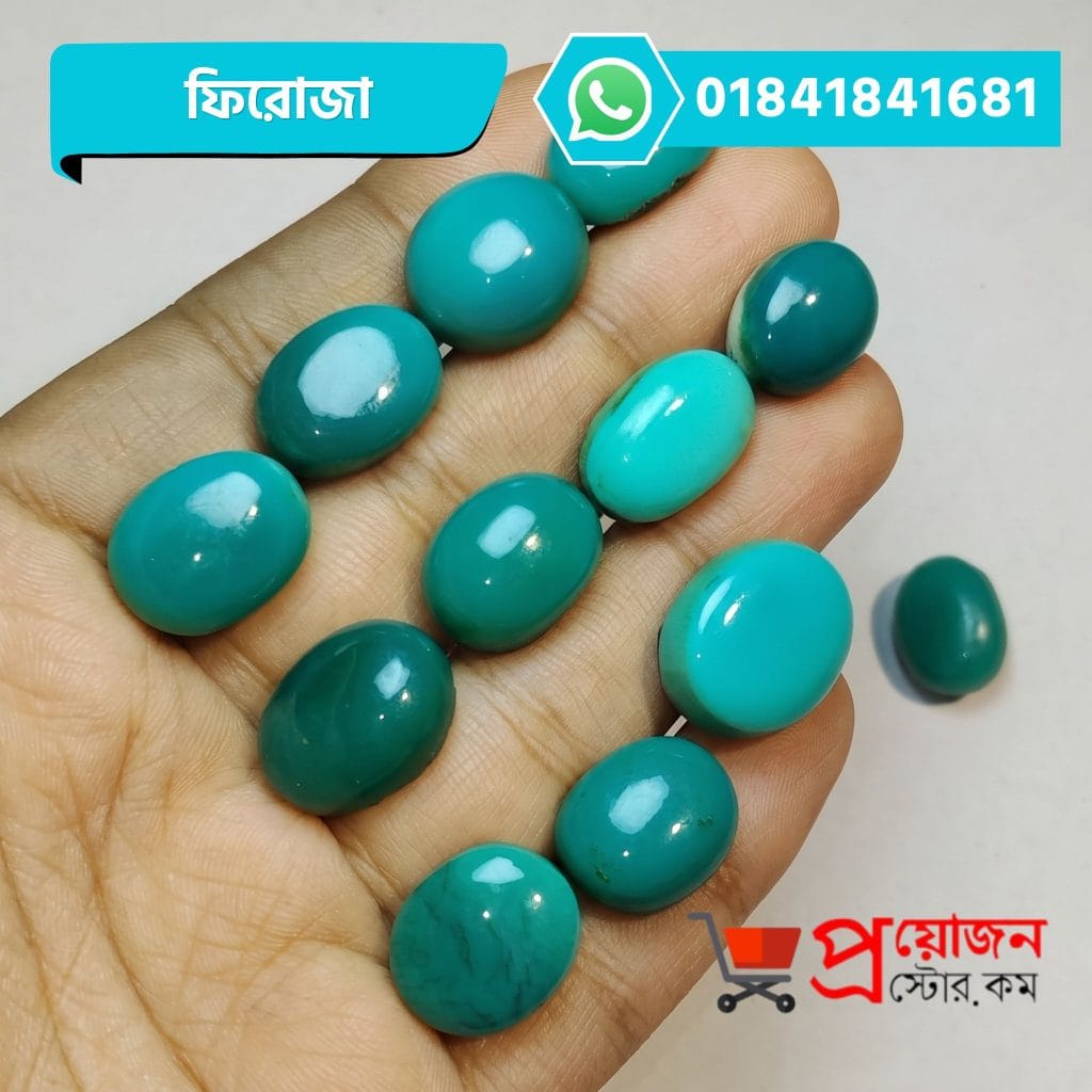 Multiple polished oval and round natural sea-green Turquoise Feroza gemstones displayed on an open hand by Proyojonstore