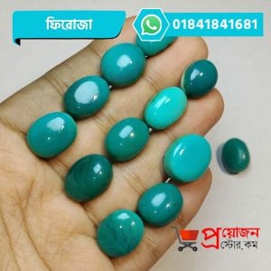 Multiple polished oval and round natural sea-green Turquoise Feroza gemstones displayed on an open hand by Proyojonstore