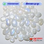 Bulk lot of loose polished natural Srilankan Blue Moonstone cabochons with blue sheen on a white background by Proyojonstore