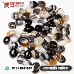 Bulk collection of natural banded black and white Solemani Akik gemstone cabochons on a white background by Proyojonstore