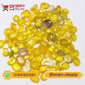 Bulk lot of loose faceted oval, cushion, and drop-cut golden-yellow Srilankan Yellow Sapphire gemstones on a white background by Proyojonstore