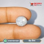 Single round original Star Blue Sapphire gemstone held between fingers showing star effect by Proyojonstore
