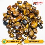 Large collection of polished oval and smooth natural Tiger's Eye gemstones arranged on a white background by Proyojonstore