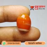 Close-up of a glossy orange and white banded natural Yemeni Akik gemstone held between fingers by Proyojonstore
