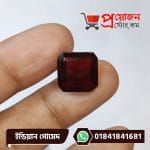 Detailed macro view of a symmetrical square-octagon cut natural dark honey-brown Indian Gomed gemstone held between fingers by Proyojonstore