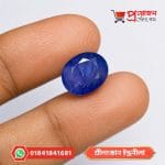 Sri Lankan Indraneelam Blue Sapphire held between fingertips