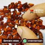 Close-up of a faceted rectangular octagon step-cut honey-brown natural Srilankan Gomed gemstone held between fingertips by Proyojonstore