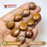 Multiple oval and round polished Mariam calligraphy stones (মারিয়াম পাথর) displayed on a hand by Proyojonstore