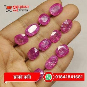 Multiple faceted oval and cushion cut pinkish-magenta natural Marka Ruby gemstones displayed on an open hand by Proyojonstore