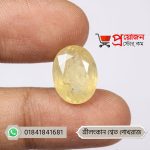 Fingertips holding a smooth faceted oval natural Srilankan White Sapphire gemstone by Proyojonstore