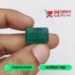 Fingertips holding a classic rectangular octagon step-cut natural green Colombian Emerald gemstone by Proyojonstore