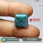 Close-up of a square translucent natural green moss agate gemstone with dendritic patterns held between fingers by Proyojonstore