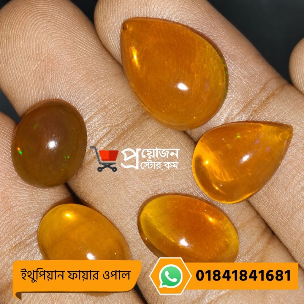 Five polished natural orange Ethiopian Fire Opal gemstone cabochons displayed on an open hand by Proyojonstore