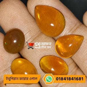 Five polished natural orange Ethiopian Fire Opal gemstone cabochons displayed on an open hand by Proyojonstore