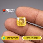 Macro close-up of a sparkling square-cushion faceted bright yellow Marka Yellow Sapphire gemstone held between fingers by Proyojonstore