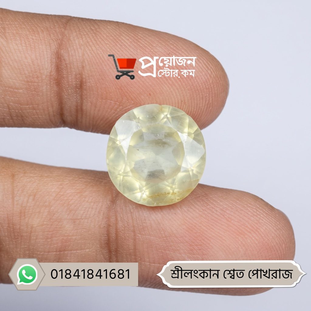 Macro close-up of a sparkling round brilliant cut natural Srilankan White Sapphire gemstone held between fingertips by Proyojonstore