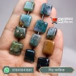 Array of multi-shaded polished square and rectangle cut natural Pitta Akik moss agate stones placed on open fingers by Proyojonstore