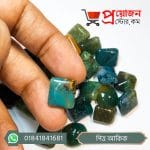 Close-up of a square cut natural green moss agate Pitta Akik gemstone held between fingers by Proyojonstore