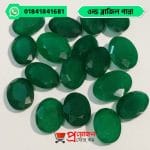 Bulk lot of loose faceted oval deep green natural Old Brazil Emerald gemstones arranged on a white background by Proyojonstore