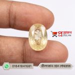 Close-up of a sparkling oval-cut natural Srilankan White Sapphire gemstone held between fingers by Proyojonstore